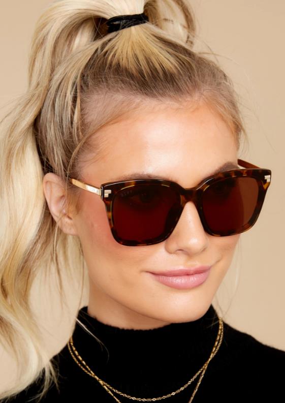 a lady wearing trendy sunglasses