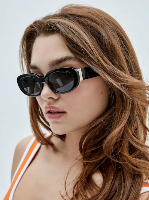 a woman wearing guess glasses