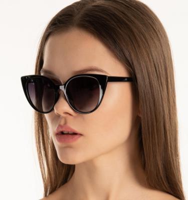 a lady wearing cat eye sunglasses