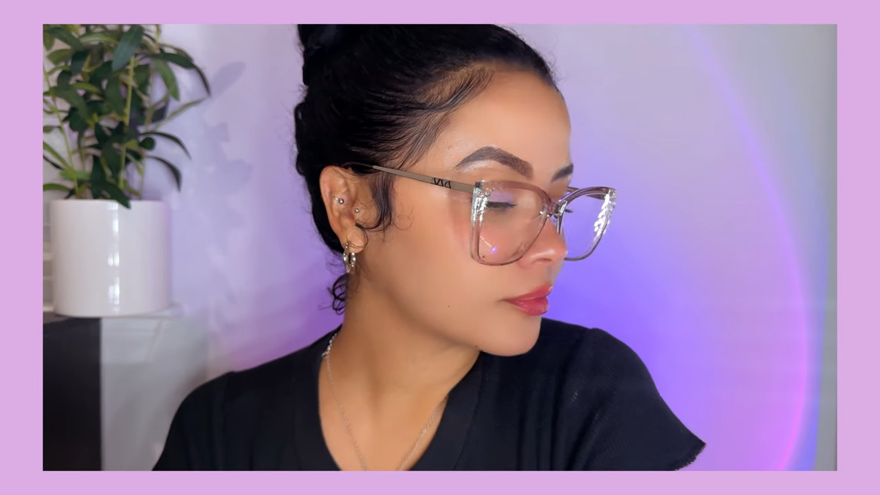 Kirsty Noskcaj wearing Lyric stylish blue light - blocking glasses, featuring a gray - purple shade with thin frames and unique indent detailing on the sides.