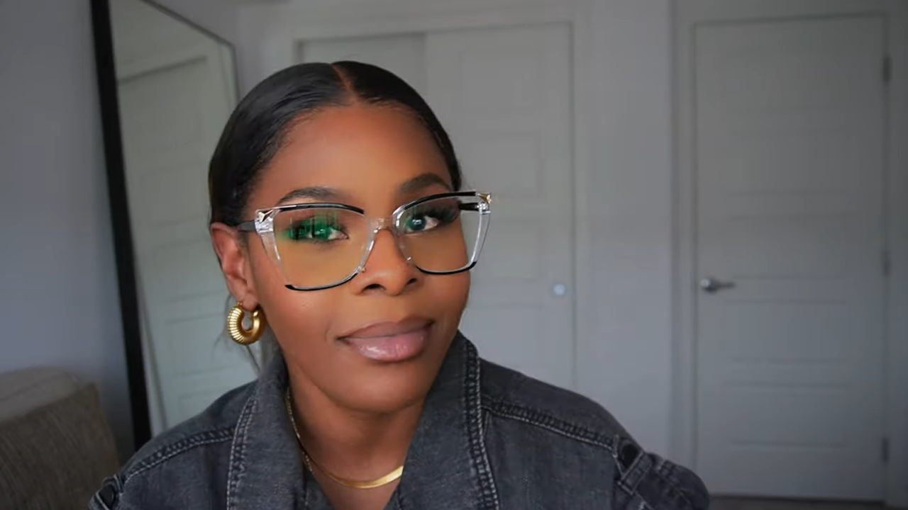 Tara Shanice wearing Lensmart Sandy transparent frames with black rims, showcasing seamless desk - to - dinner style.