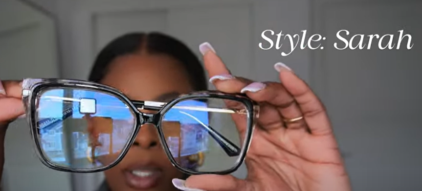 Tara Shanice holding Lensmart Sarah frames – black/tortoise pattern with gold accents and blue light filtering, ideal for digital eye defense.
