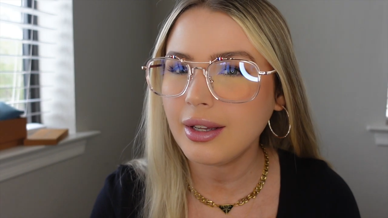 Michaela wearing Desmond golden - framed glasses with red, white, and blue accents on arms, noted for good quality, weight, durable build, and comfortable nose pieces.