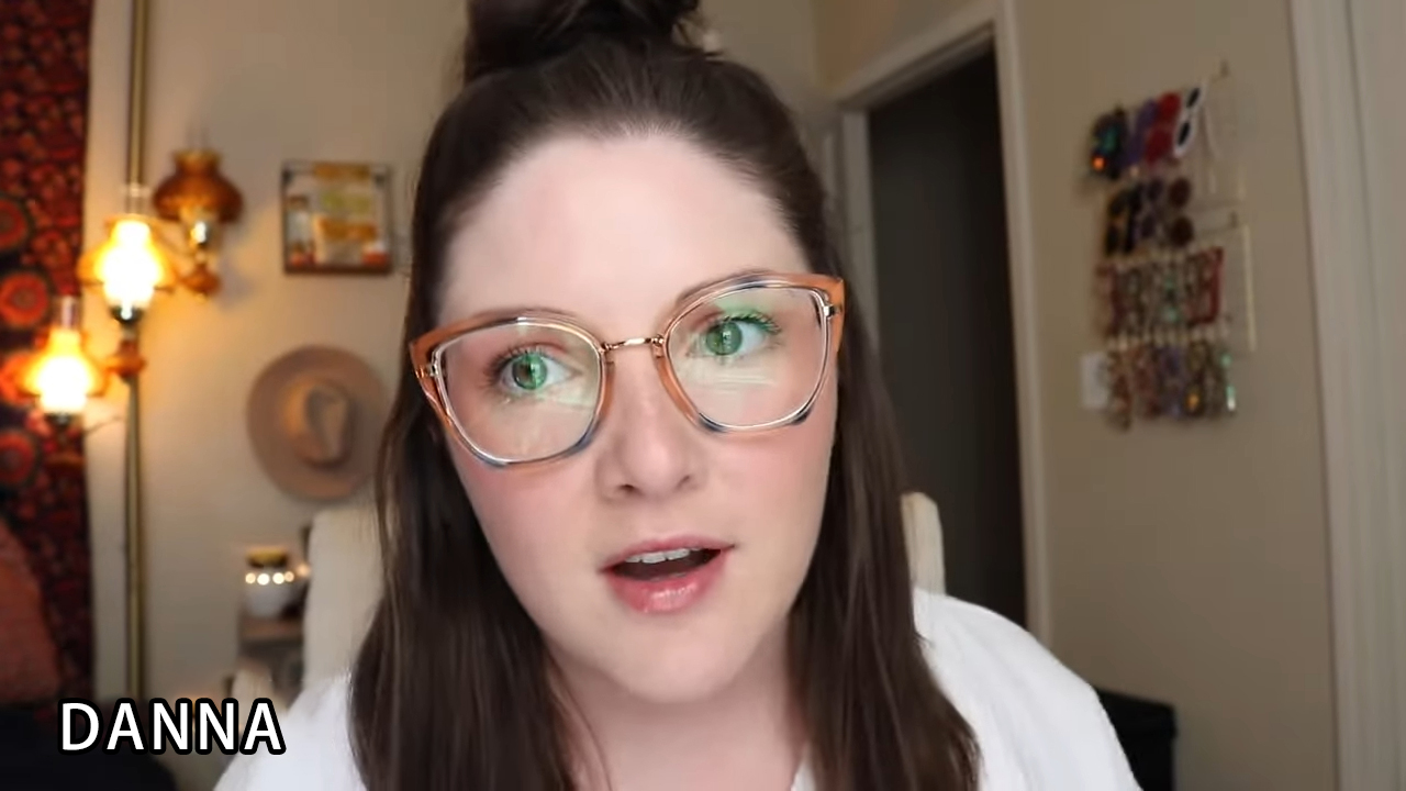 Hannah wearing Lensmart Dana frames, showcasing the orange - blue gradient and flattering cat - eye shape.