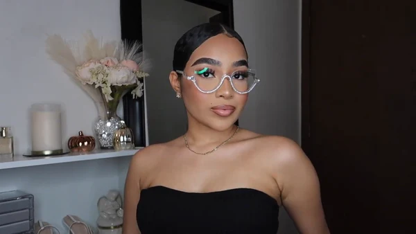 Symphony Taylor wearing Lensmart blingy cat - eye glasses with white diamonds, showcasing their sparkling accents, retro flair, and confidence - boosting style.