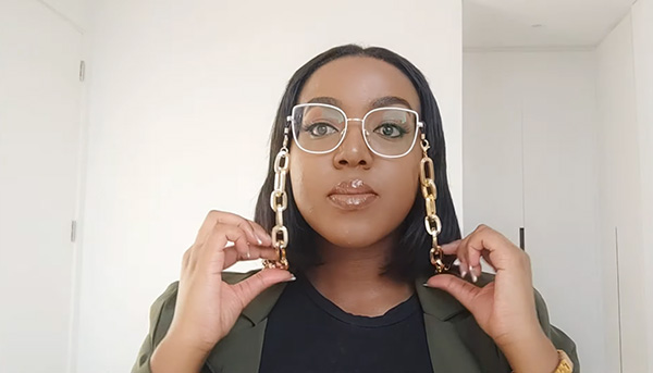 Namolinah wears Lensmart Maxwell glasses with shoe - decor temples, paired with a trendy chain for style & practicality.