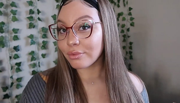 Tianna Brown wearing Lensmart Aiyana red cat-eye glasses, showing how the bold red frames suit her round face.