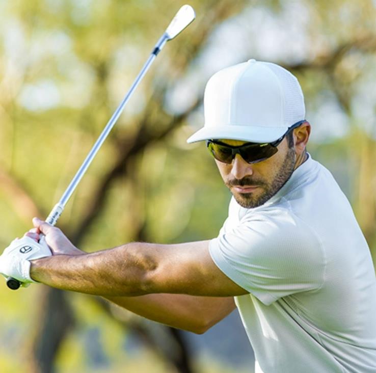 A man wearing golf sunglasses
